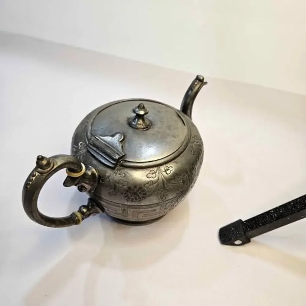 Antique silver-plated teapot Greek key pattern & embossed floral motifs.